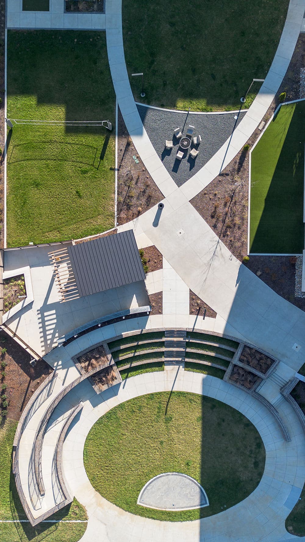 Aerial view of a modern park with pathways, seating areas, and green spaces.